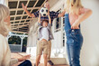 © Marko Geber - Grandparents and grandchildren having fun on home porch with football
