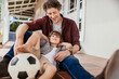 © Marko Geber - Father and son playing with soccer ball on porch