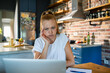 © Geber86 - Young woman stressed while working from home on a laptop in kitchen