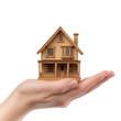 © betterpick|Art - Wooden House Model in Hand for Real Estate Concept