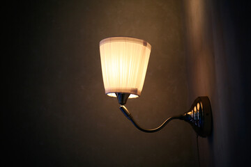 close up a lighting lamp hanging on the wall