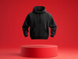 © G - Blank Black Mockup Hoodie design floating above a podium with an isolated neutral red color background