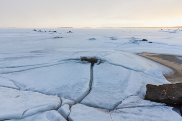 Wall Mural - landscape with frozen baltic sea at sunset. cracked ice
