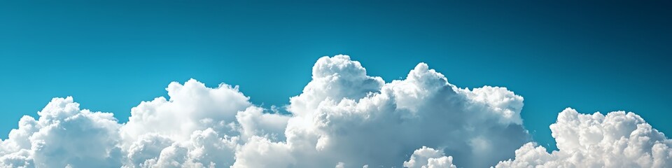 Wall Mural - A serene sky filled with fluffy white clouds against a bright blue backdrop.