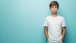 © Eric - A teenage boy with his hands in his pockets, looking dejected on a pale blue background.