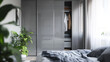 © Sadia - Modern bedroom interior featuring a sleek wardrobe and cozy plants in a bright space during daylight hours