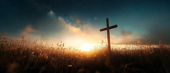 A cross is standing in a field of tall grass