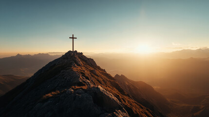 Wall Mural - A cross is on top of a mountain, with the sun setting in the background