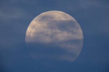 Wall Mural - photograph of the full moon partially covered with clouds