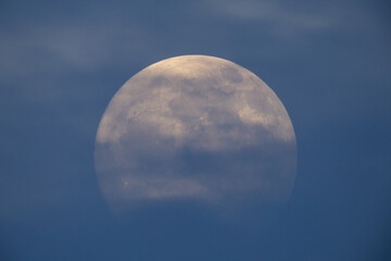 Wall Mural - photograph of the full moon partially covered with clouds