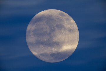 Wall Mural - photograph of the full moon partially covered with clouds