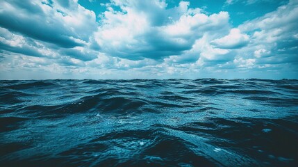 Poster -  An image of the ocean with cloudy skies and clear blue water