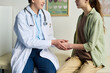 © pressmaster - Doctor speaking with patient in clinical office, both individuals seated as they talk about treatment options, patient wearing casual clothes while doctor in white coat