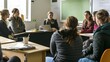 © Felippe Lopes - Group of young women in a classroom setting listening intently to a presentation.