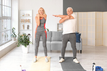 Sticker - Sporty mature couple training at home