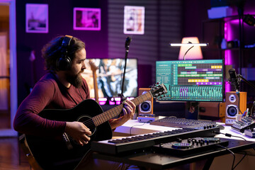 Poster - Music producer playing accords on acoustic instrument and recording tunes on daw software, prepares for mixing and mastering techniques. Young artist producing soundtracks with guitar.