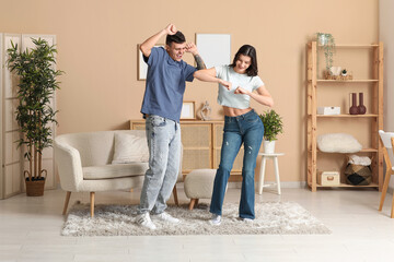 Sticker - Happy young couple dancing in living room