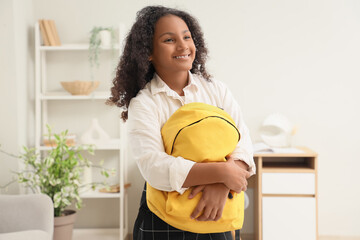 Canvas Print - Little African-American schoolgirl with backpack at home