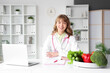 © Pixel-Shot - Female nutritionist sitting at table in office