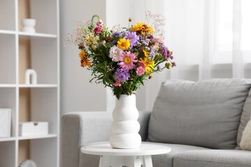 Canvas Print - Vase with wild flowers on coffee table in interior of living room. Closeup