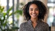 © Thanthara - Professional woman with headset smiles confidently, representing customer service and support in a clean environment.
