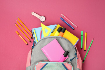 Canvas Print - Backpack and different school supplies on pink background, flat lay