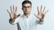 © Sparrow Studio - Bearded man wearing glasses and a white shirt makes a gesture of prohibition