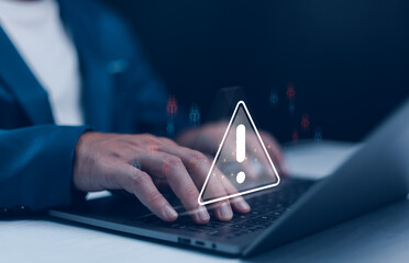 Businessman or it staffs, programmer, developer using laptop with triangle caution warning sign for notification error and maintenance concept. Virus detected warning, Cybercrime protection