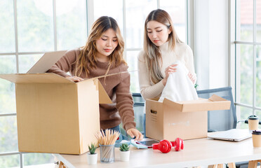 Wall Mural - Portrait two roommates happy young Asian female moving packing things in box into new apartment, carry cardboard boxes, Concept teenage or friends, Real estate property buying, relocation, new home