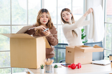 Wall Mural - Portrait two roommates happy young Asian female moving packing things in box into new apartment, carry cardboard boxes, Concept teenage or friends, Real estate property buying, relocation, new home