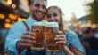 © ZHIJIAN - A cheerful couple in traditional Bavarian attire enjoying a beer at an Oktoberfest celebration, surrounded by warm lights and festive atmosphere.
