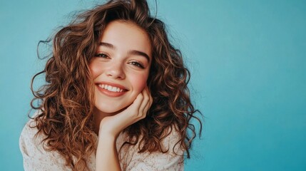 Pretty woman with curly hair smiles for photo.