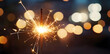 © Oksana - Glittering burning sparkler against blurred bokeh light background. New Year's Eve celebration