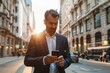 © kitipol - Man in suit completing online purchase on smartphone, professional working on the go, city setting