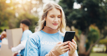 Wall Mural - Phone, volunteer and woman in park for charity event, community service and inventory. Volunteering, ngo outreach and person on smartphone for social media, internet and online website outdoors