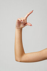 Wall Mural - Woman's Arm Extended With Hand Open and Fingers Against a White Background