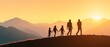 © sceneperfect - A silhouette of a family walking hand in hand at sunset, surrounded by mountains, symbolizing togetherness and adventure.