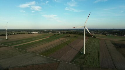 Wall Mural - Windmills in open countryside during sunset