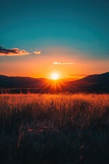 Wall Mural - Stunning Sunset Over a Serene Meadow with Golden Grass and Majestic Mountains in the Background