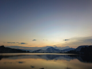 reflection of the evening sunset on a beautiful lake background with a blue orange sky