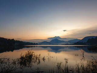 reflection of the evening sunset on a beautiful lake background with a blue orange sky