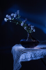 Canvas Print - wild summer flowers in dark glass vase on dark blue background