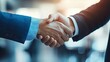 © Pricha.RT - Close-up shot of a professional handshake between two business individuals in formal attire, symbolizing agreement and partnership, set in a modern office environment.
