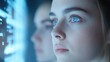 © Whitefeather - A woman with blue eyes is looking at a computer screen. Concept of focus and concentration as the woman stares intently at the screen. The blue color of the eyes and the screen creates a calming