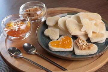 Toasted bread hearts with peanut butter and jam. Breakfast for holidays. Food for good vibe. 