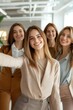 © Onzdemia - Female-led team taking a selfie in a bright and modern office, empowered women, leadership and teamwork, casual office attire