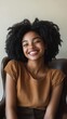 © Big - Confident and Radiant: Joyful African American Woman Relaxing in Chair. Empowering Portrait of Beauty, Comfort, and Self-Assurance. Minimalist Artistic Composition for Diverse Representation in Market