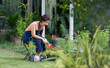 © toa555 - Senior asian woman gardening in frontyard. Life after retirement concept.