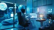 © VK Studio - A researcher in a modern lab, illuminated by cool blue lighting, works at a computer workstation with a patient bed in the background.