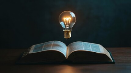 Incandescent lamp on an illustrated book on the concept of knowledge